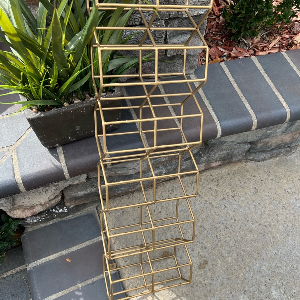 Gold wall mounted wine rack